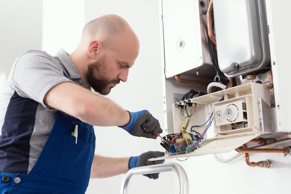 Plumber man working on boiler